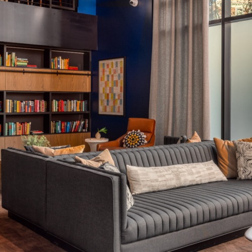 Luxury apartment lounge with books, seating, and relaxed ambiance