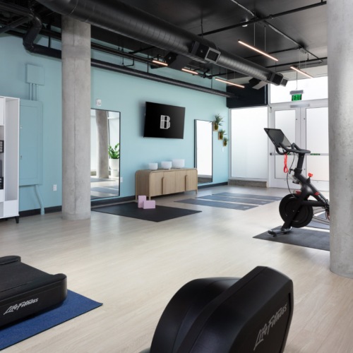Bright apartment gym with exercise machines and sleek modern interior