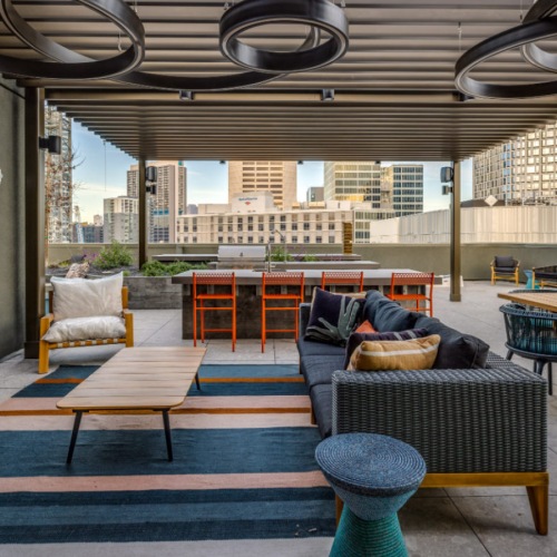 Luxury rooftop terrace with lounge seating and San Francisco skyline views